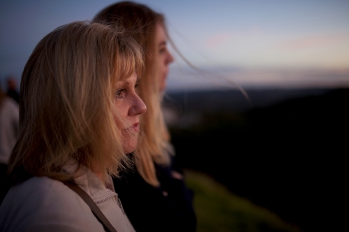 Two women at a lookout at dusk - Australian Stock Image