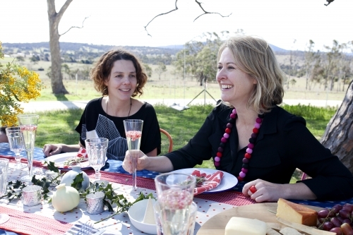 Two women sitting at a table outside on Christmas day - Australian Stock Image