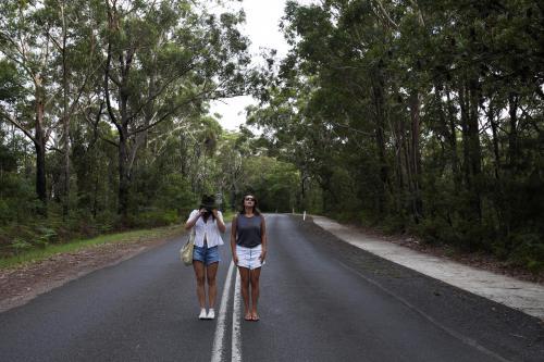 Two women standing in the middle of the road - Australian Stock Image