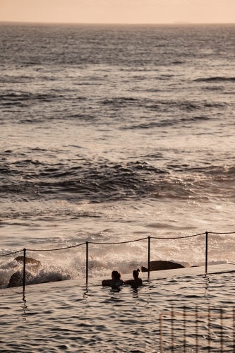 Two women swimming in the Bronte Ocean Pool (Bronte Baths) at sunrise