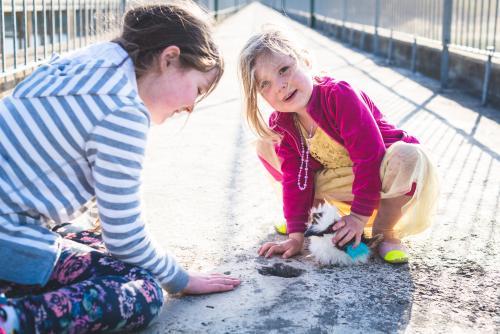 Two young girls sitting on a bridge - Australian Stock Image