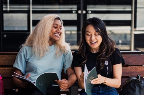 two young women waiting at the train station - Australian Stock Image