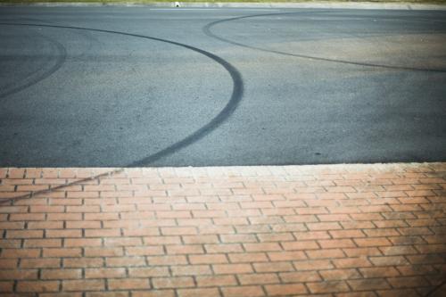 Tyre marks on a suburban road.