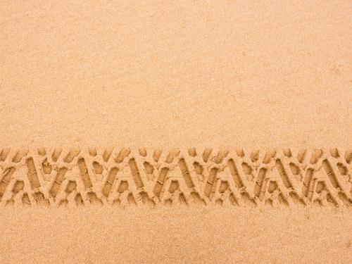 Tyre tread pattern in beach sand - Australian Stock Image