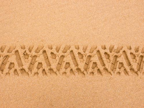 Tyre tread pattern in beach sand - Australian Stock Image