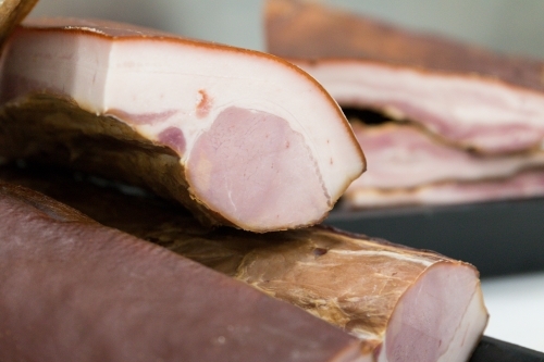 Uncut pork on trays in butcher shop - Australian Stock Image