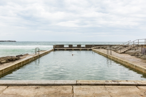 Up close view of woman swimming in ocean pool at beach - Australian Stock Image