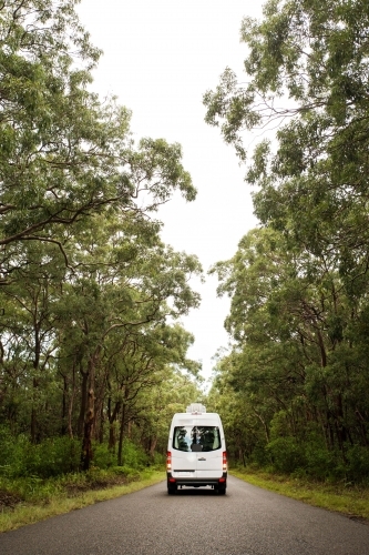 Van driving down bushland road - Australian Stock Image