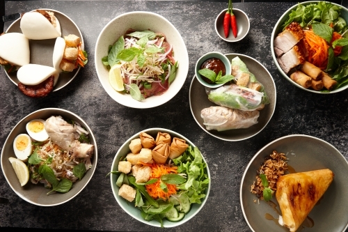 Various Asian food dishes on table - Australian Stock Image