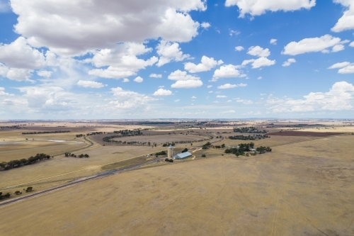Vast land of paddocks and silos in the distance. - Australian Stock Image