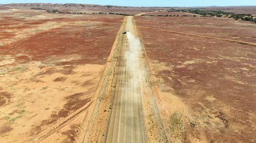 Vehicle driving along outback road - Australian Stock Image