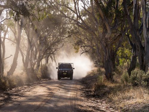 Vehicle travelling along a dusty dirt road