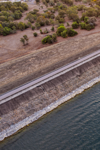 Vertical Aerial close up view of the Glenbawn Dam wall and surrounding landscape in NSW Australia. - Australian Stock Image