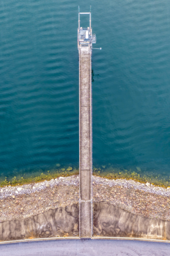 Vertical Aerial downward view of the Glenbawn Dam wall with the walkway and water intake - Australian Stock Image
