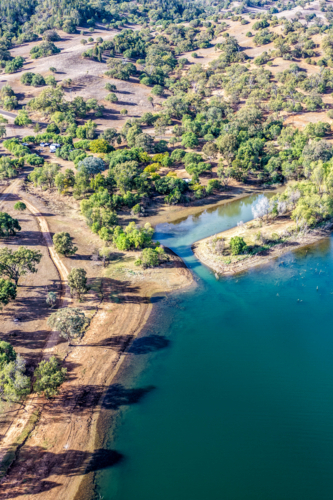 Vertical Aerial view of Glenbawn Dam and camping areas along the shoreline - Australian Stock Image