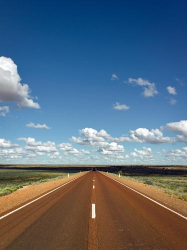 Vertical aspect of long straight Highway in outback - Australian Stock Image
