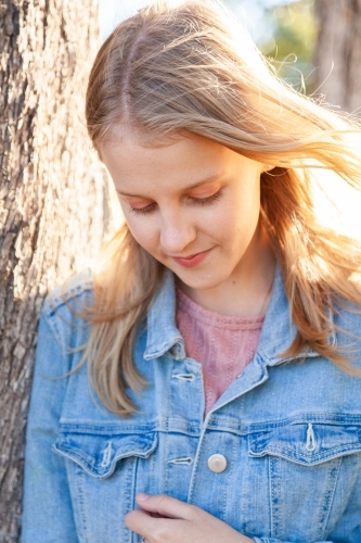 Vertical portrait of a teen girl looking down - Australian Stock Image