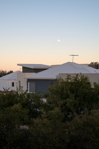Vertical view of sunset over roof tops - Australian Stock Image