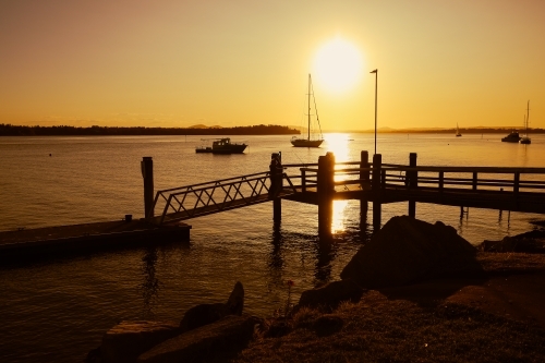 Vibrant afternoon sunset over jetty at Iluka in NSW Australia