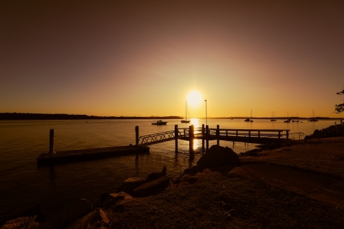 Vibrant afternoon sunset over jetty at Iluka in NSW Australia - Australian Stock Image
