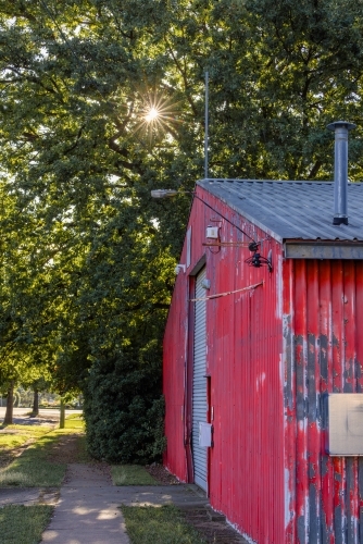 Vibrant red shed with large white door - Australian Stock Image