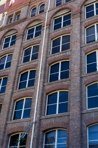 Victorian warehouse architecture with brick and white window framing - Australian Stock Image