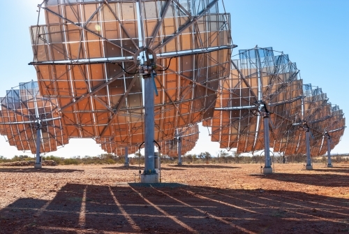 View behind set of solar panel dishes in regional Australia - Australian Stock Image
