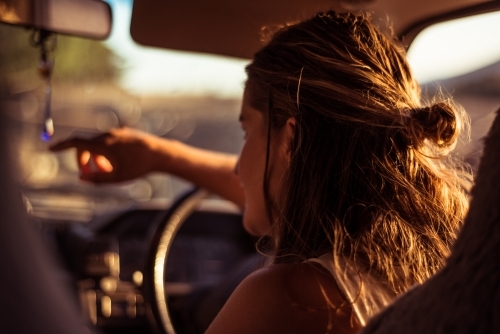 View from back of vehicle of woman driving van in regional area - Australian Stock Image