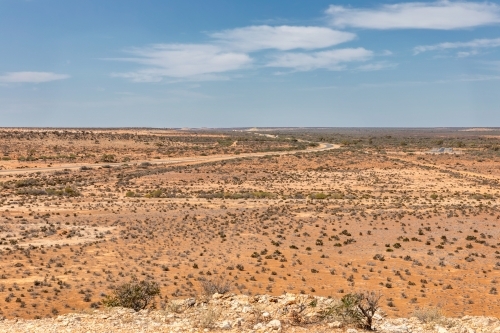 View from Gladstone Scenic Lookout showing road winding through flat,dry expanse - Australian Stock Image