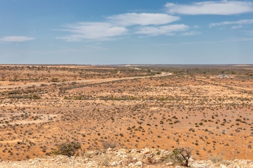 View from Gladstone Scenic Lookout showing road winding through flat,dry expanse