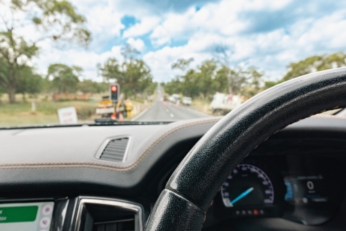 View from inside vehicle stopped at red light at roadworks in the country - Australian Stock Image