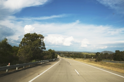 View from out the front of a car, of highway in country area