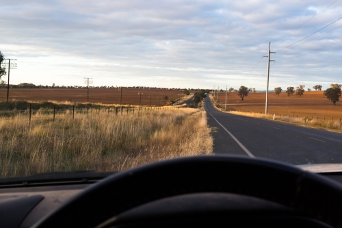 View from the interior of a car onto a country road