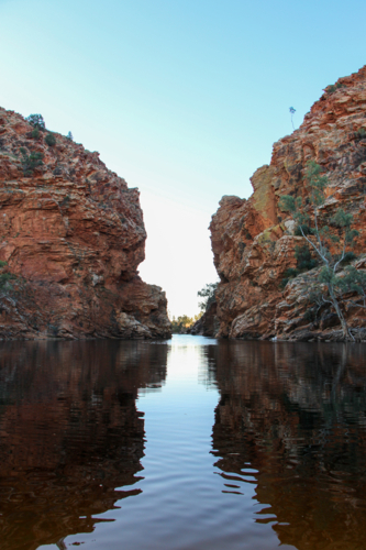View looking down the rocky gap at a remote swimming hole - Australian Stock Image