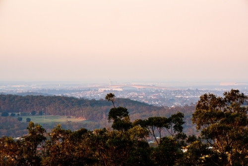 View of across Brisbane  suburbs to Gateway Bridge in the smoke haze - Australian Stock Image