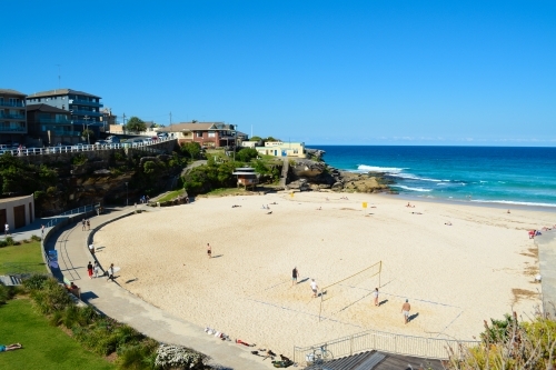 View of beach with sand in foreground and ocean in background - Australian Stock Image