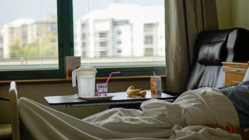View of hospital room window with patient in foreground