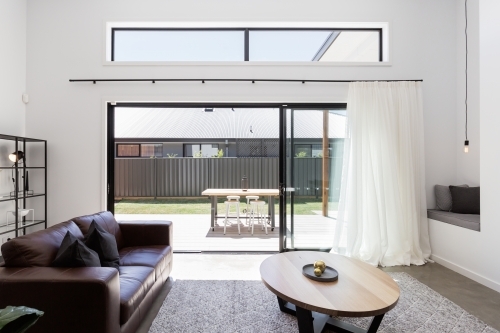 View of outdoor deck from a luxury living room - Australian Stock Image
