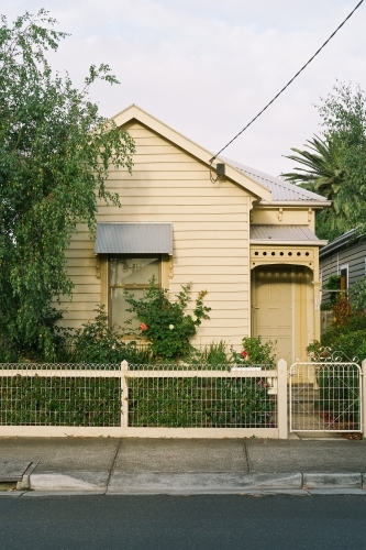View of surburban house front gate with tree in front garden - Australian Stock Image