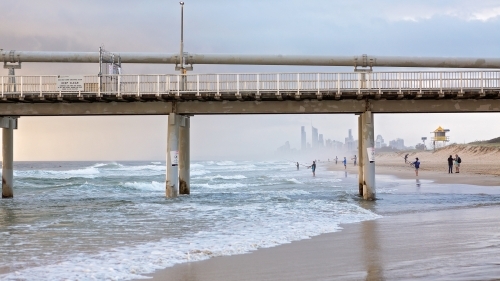 View of surfers paradise through sand pumping jetty at The Spit - Australian Stock Image