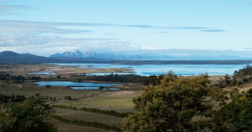 view of The Hazards and Freycinet Peninsula across a bay - Australian Stock Image