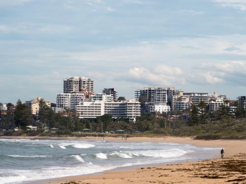 View of Wollongong across a beach and surf