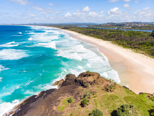 view over Wommin Bay from Fingal Head lighthouse towards Kingscliff in New South Wales - Australian Stock Image