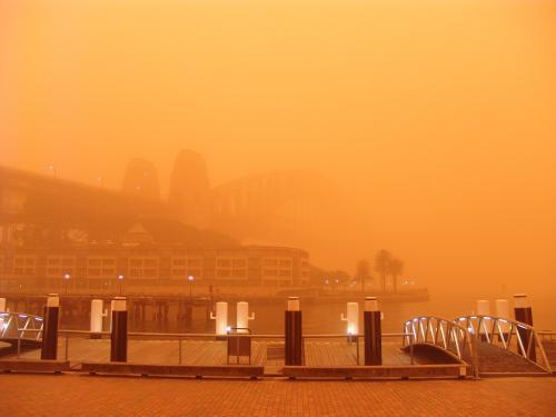 View through red dust storm of Sydney Harbour Bridge