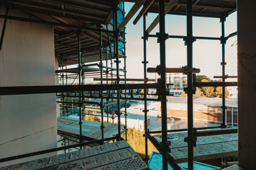 View through scaffolding on side of building in urban setting - Australian Stock Image