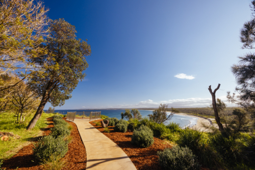 Views from Broulee lookout over Broulee Beach on a warm sunny spring day - Australian Stock Image