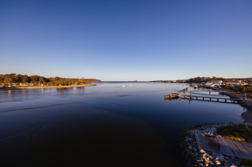 Views from Foreshore Park in Batemans Bay along the Clyde River on a warm sunny spring evening - Australian Stock Image