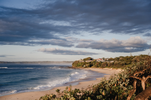 village on the beach with moody sky - Australian Stock Image
