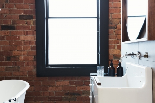Vintage warehouse bathroom with large blank window - Australian Stock Image