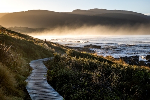 walking path beside the beach at sunrise - Australian Stock Image